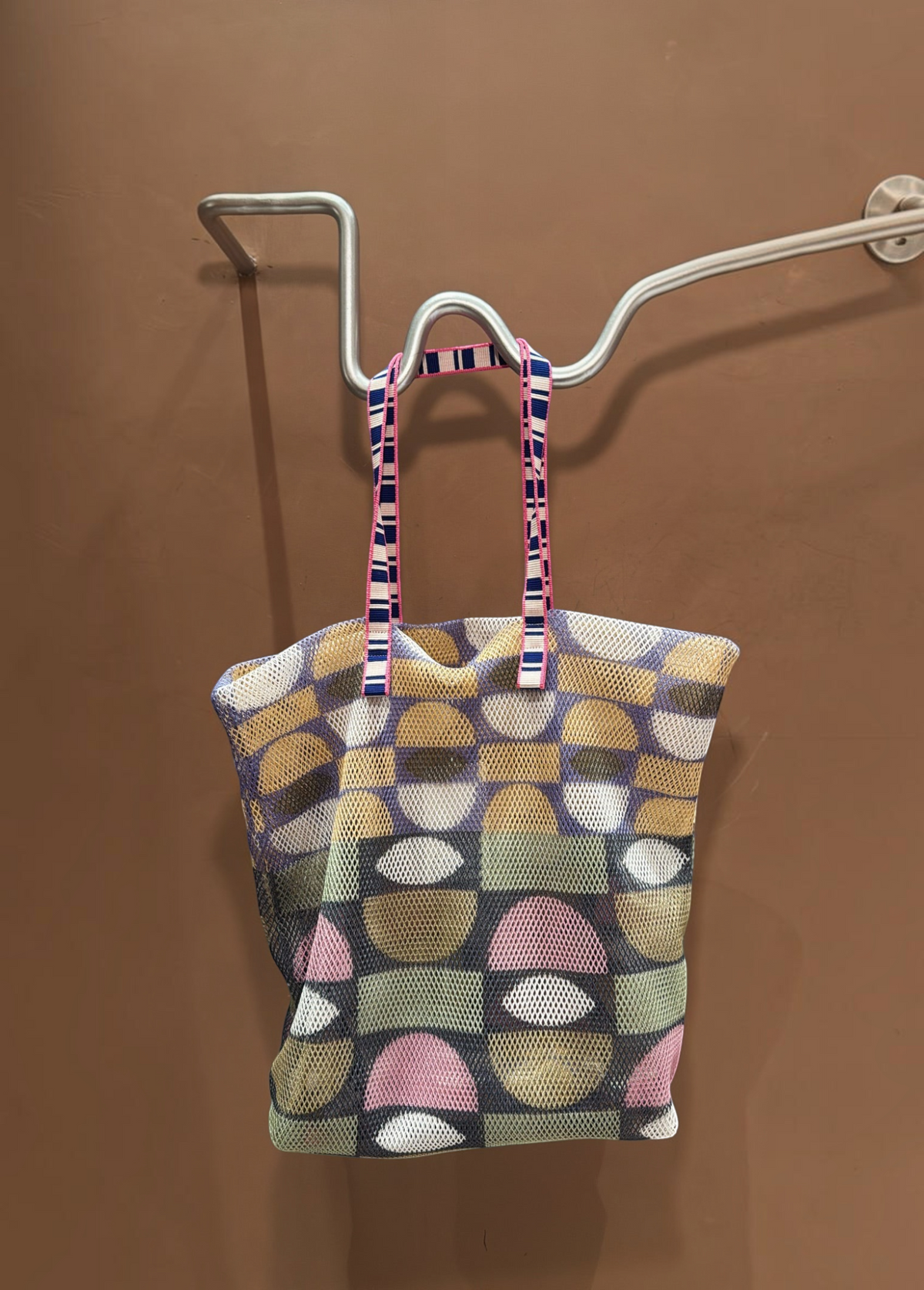 KABE SHOP INC Kanpur bag featuring a geometric multi-colored mesh pattern and striped fabric handles