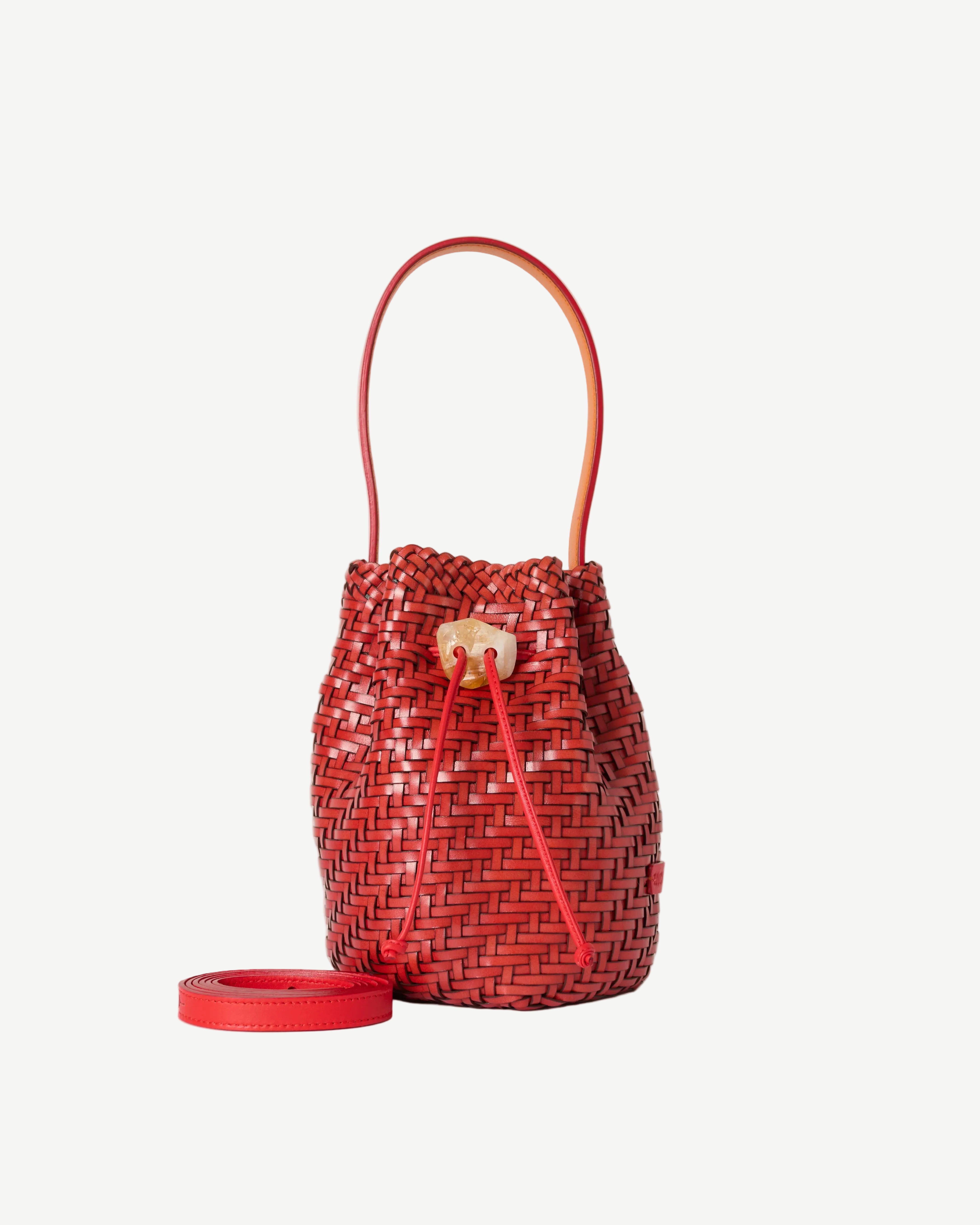 Red woven bucket bag on a white background