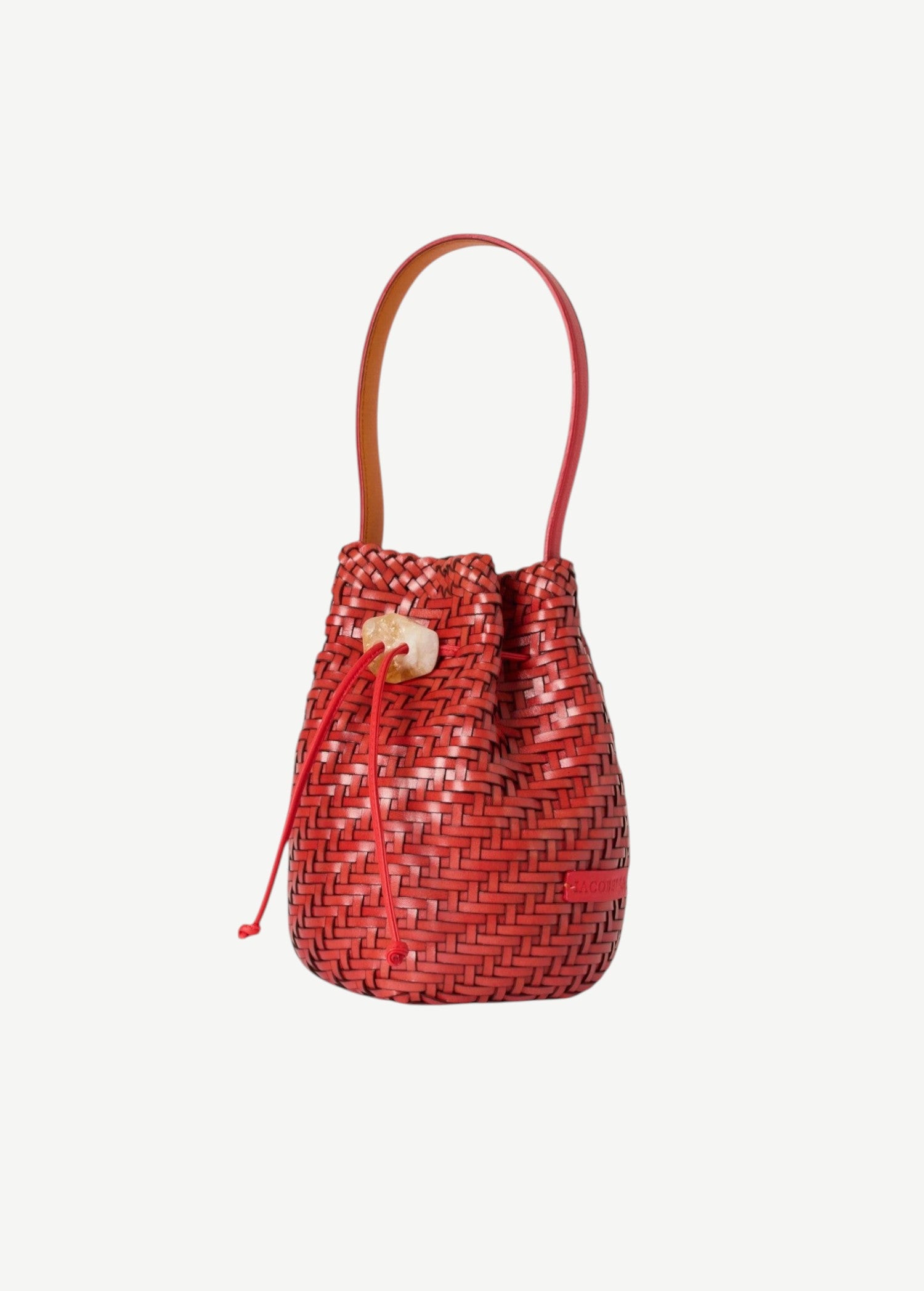 Red woven bucket bag with a handle on a white background