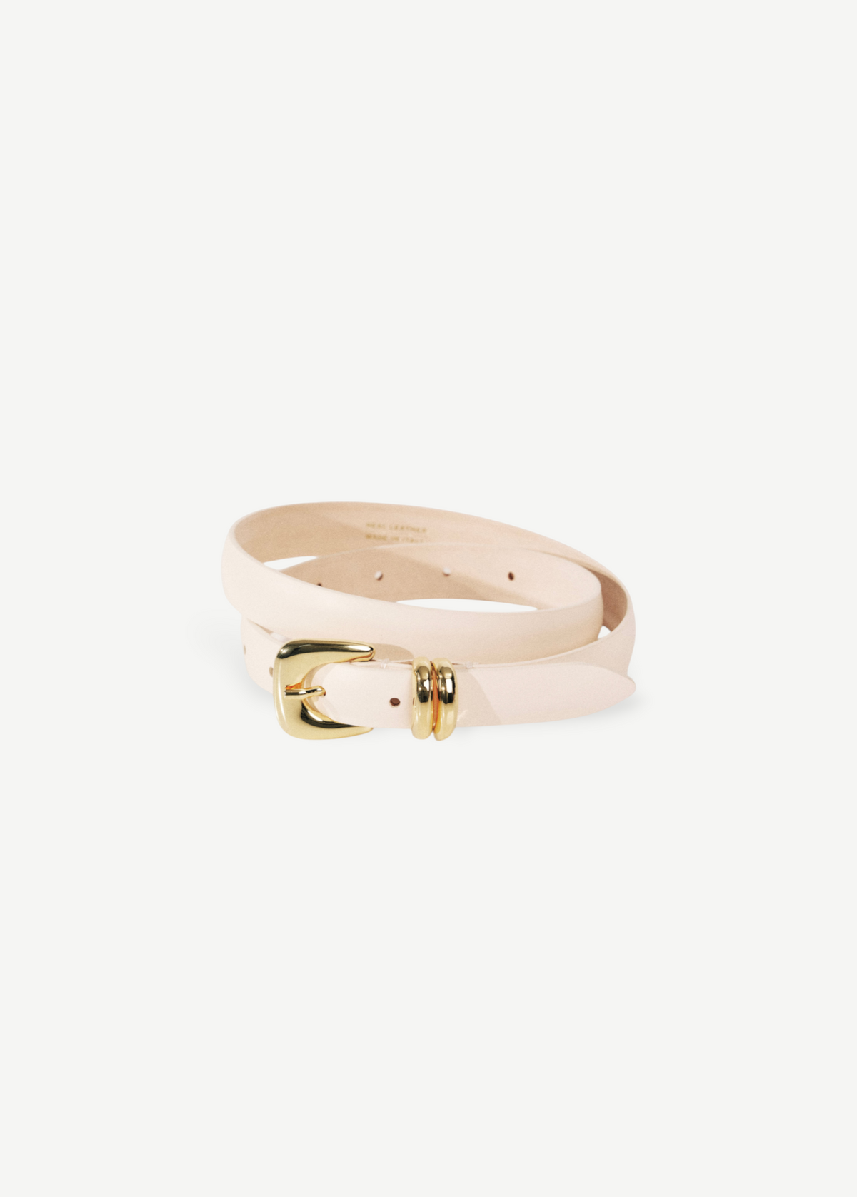 KABE SHOP INC Altura belt in cream Italian calfskin leather with a polished gold curved buckle on a neutral background
