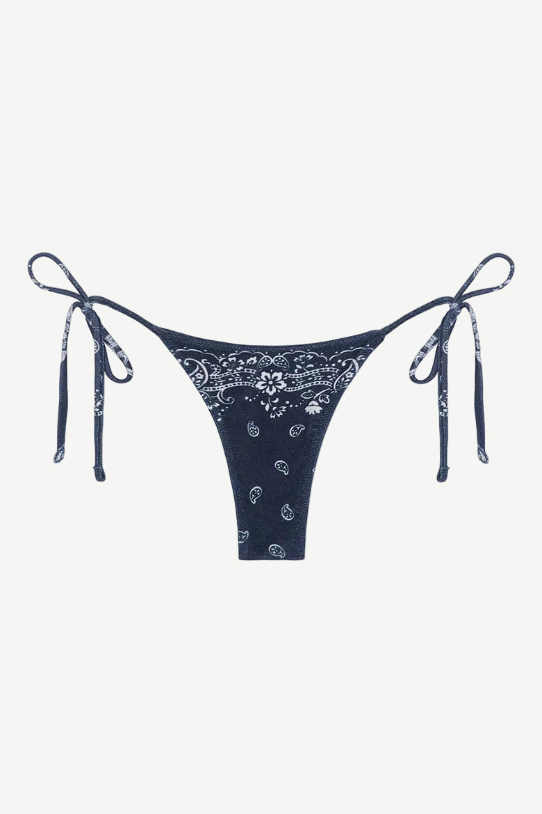 Praia Bottom in navy blue with a white paisley bandana print, crafted from eco-terry fabric, features a low-rise silhouette and adjustable side ties, shown on a white background.