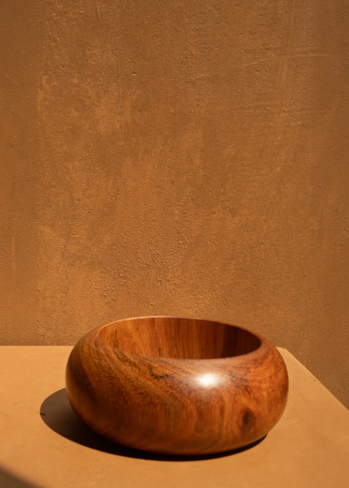 KABE SHOP INC set of three sculptural bangles made from natural wood and resin with a modern, minimalist design.