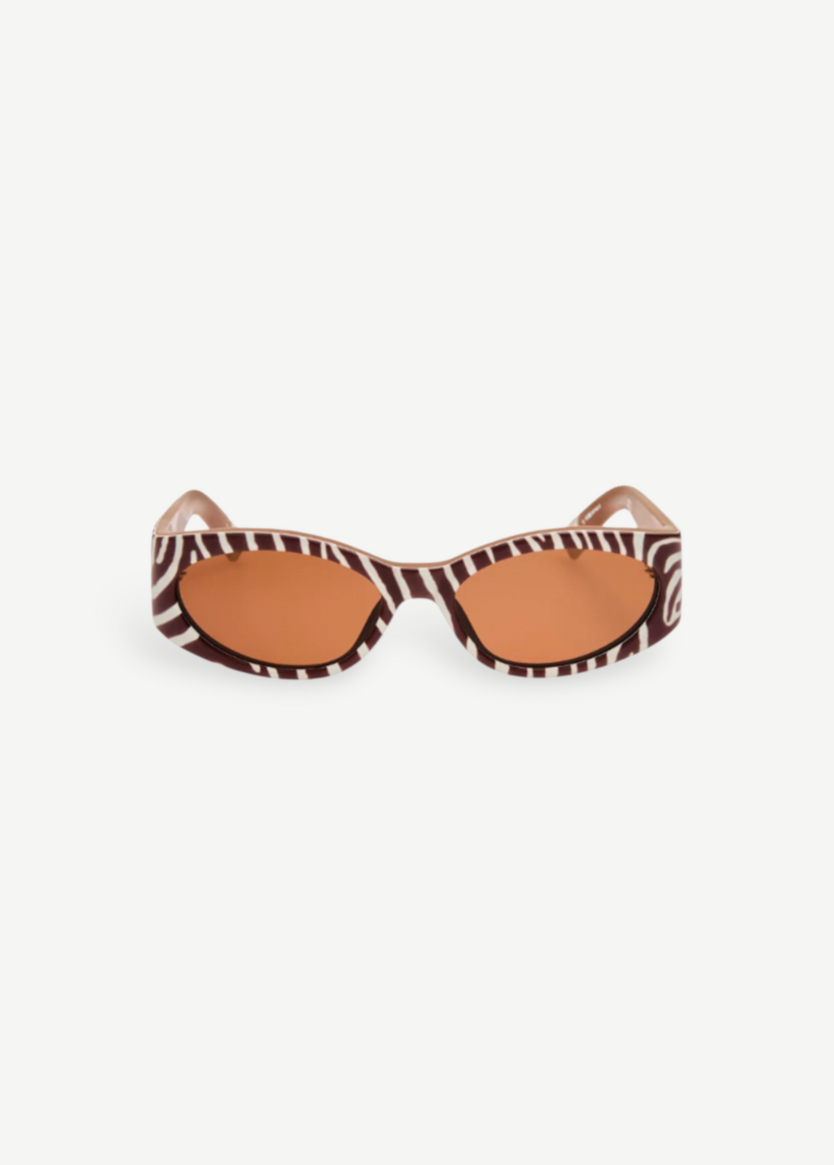 KABE SHOP INC Ovalo sunglasses featuring a bold zebra print oval frame and warm amber tinted lenses.