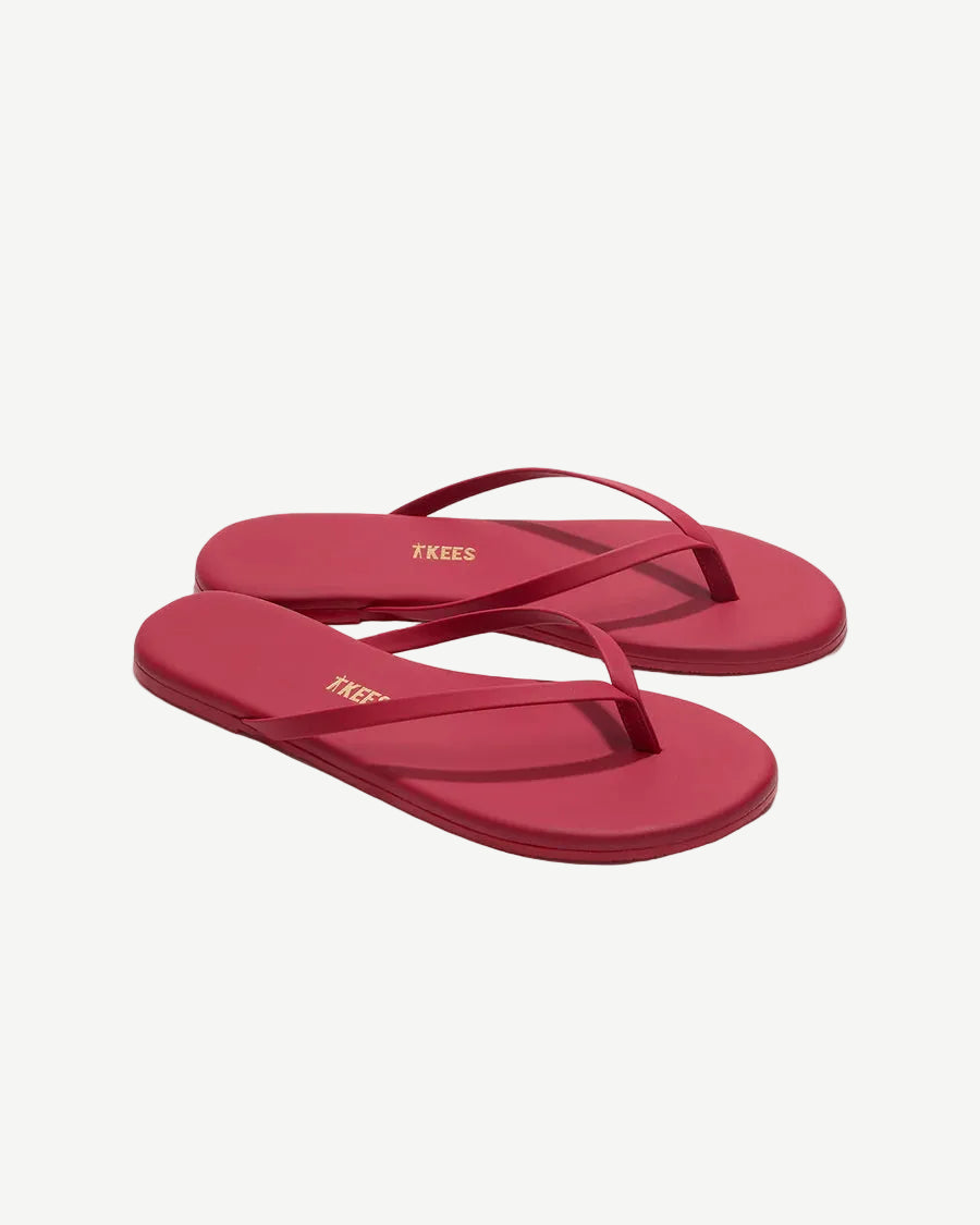 Red flip-flops with a brand logo on a white background