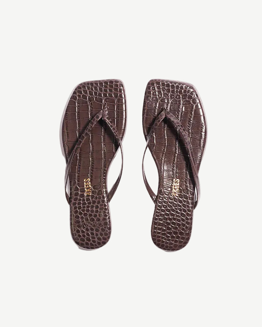 Pair of brown flip-flops with a textured pattern on a white background