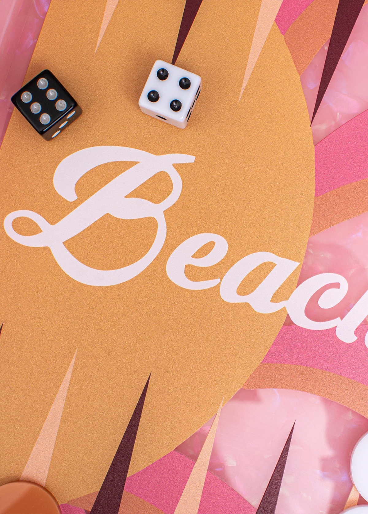 The Miami Backgammon Board Game features a pink acrylic board with vibrant orange accents and the word “Beach” written in white script, surrounded by dice and game pieces. This stylish set comes packaged in a chic gift box, making it the perfect choice for any game enthusiast.