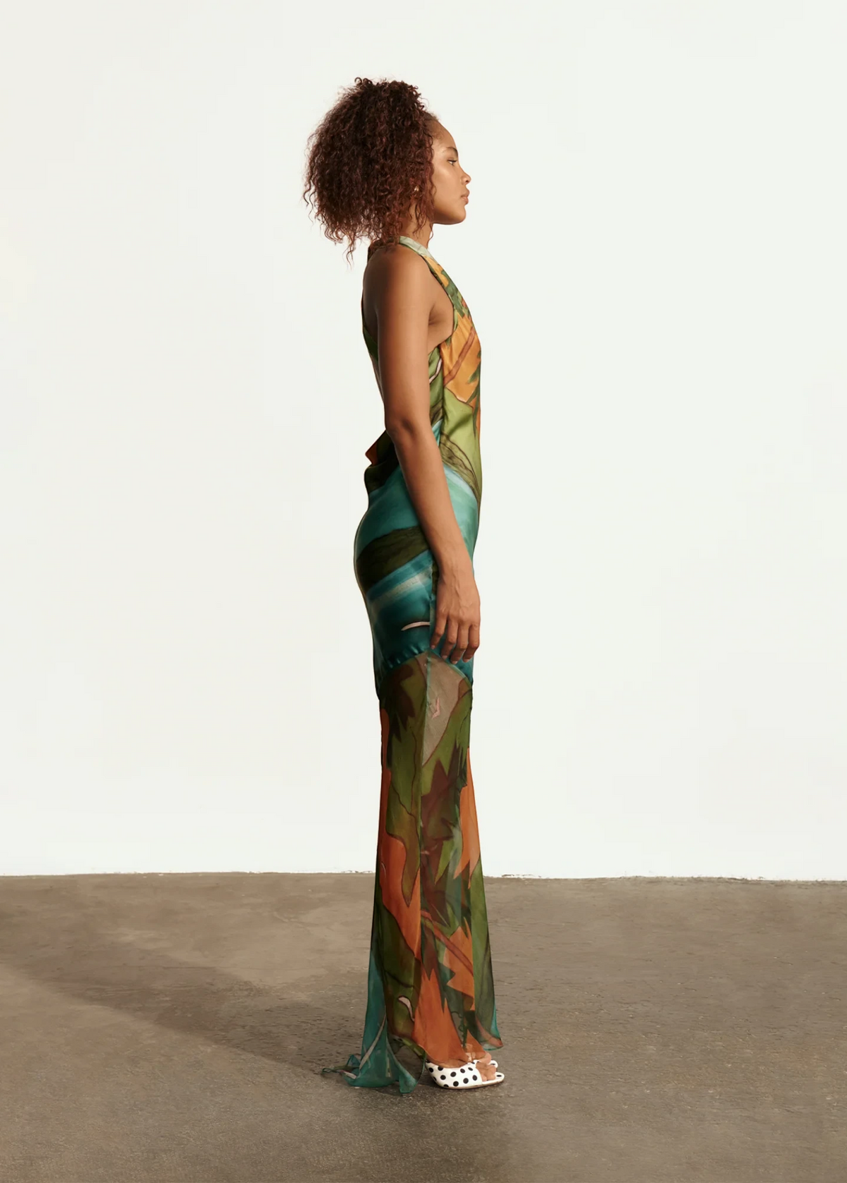 KABE SHOP INC Magdalena long silk maxi dress with halter neckline and abstract landscape print on a model side view