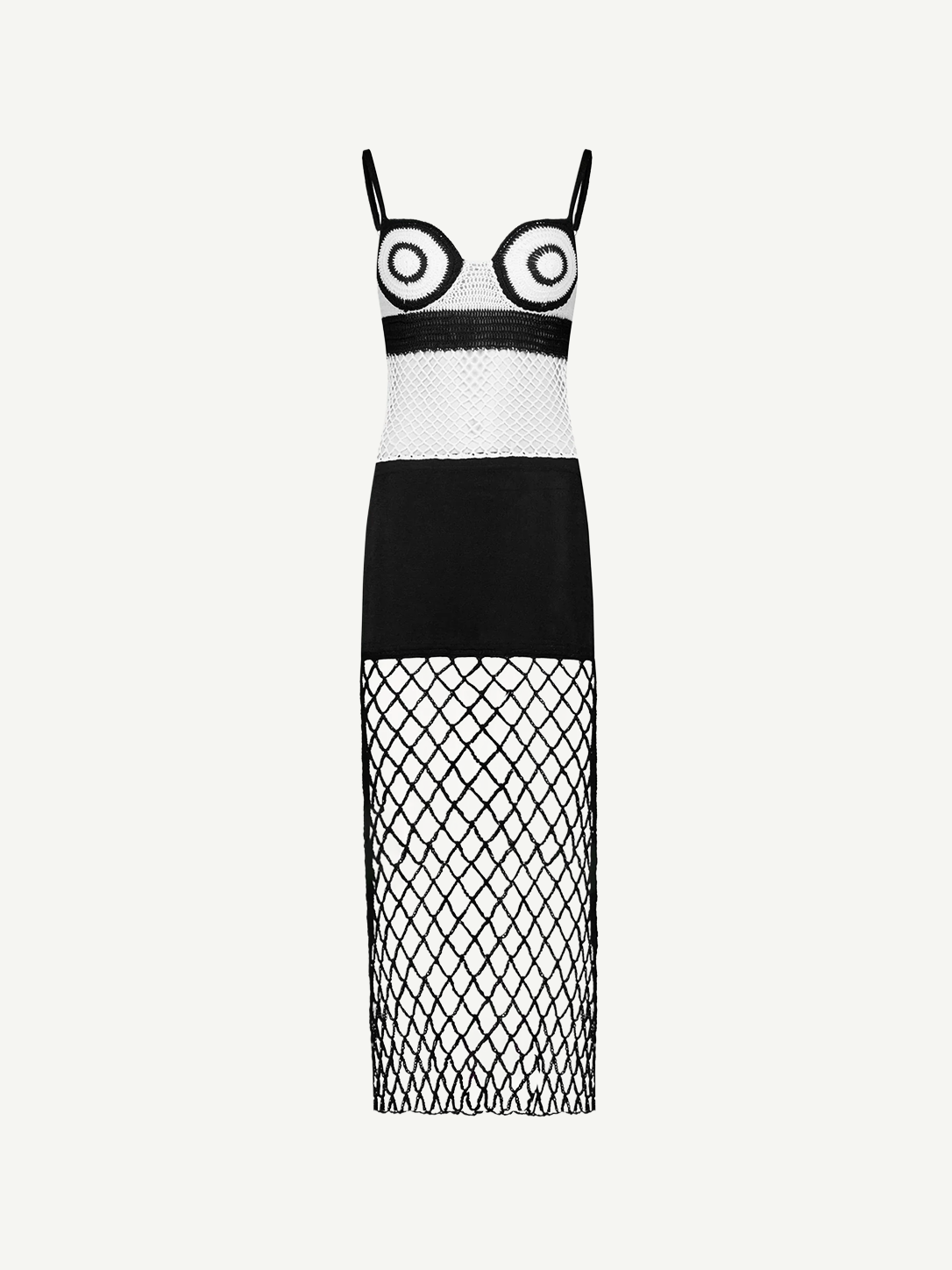 La Femme Dress: This black-and-white sleeveless dress features thin straps and bold circular patterns on the bodice, complemented by a solid black midsection. The skirt is crafted from crochet fabric with see-through diamond-patterned netting, creating an elegant yet modern look. Photographed against a plain white background.