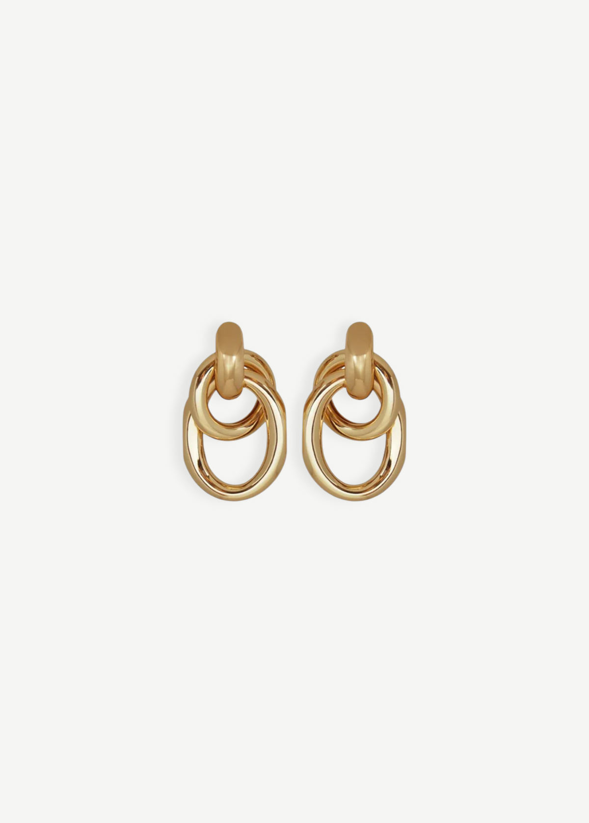 The Ami Earrings are a pair of pierced back earrings, each showcasing three interlocking circular loops, beautifully crafted in 14KT gold plate with an elegant 1.5-inch drop, shown against a plain white background.
