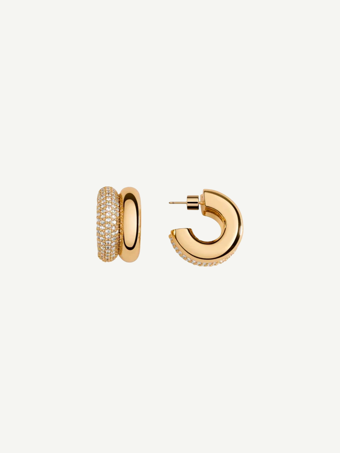 Introducing the CZ Double Hoop Earrings: a pair of elegant 14KT gold-plated double hoops, featuring one side exquisitely encrusted with pave cubic zirconia for added brilliance. One earring is showcased from the front to highlight its captivating sparkle, while the other is displayed from the side to reveal the sleek post and secure clasp.