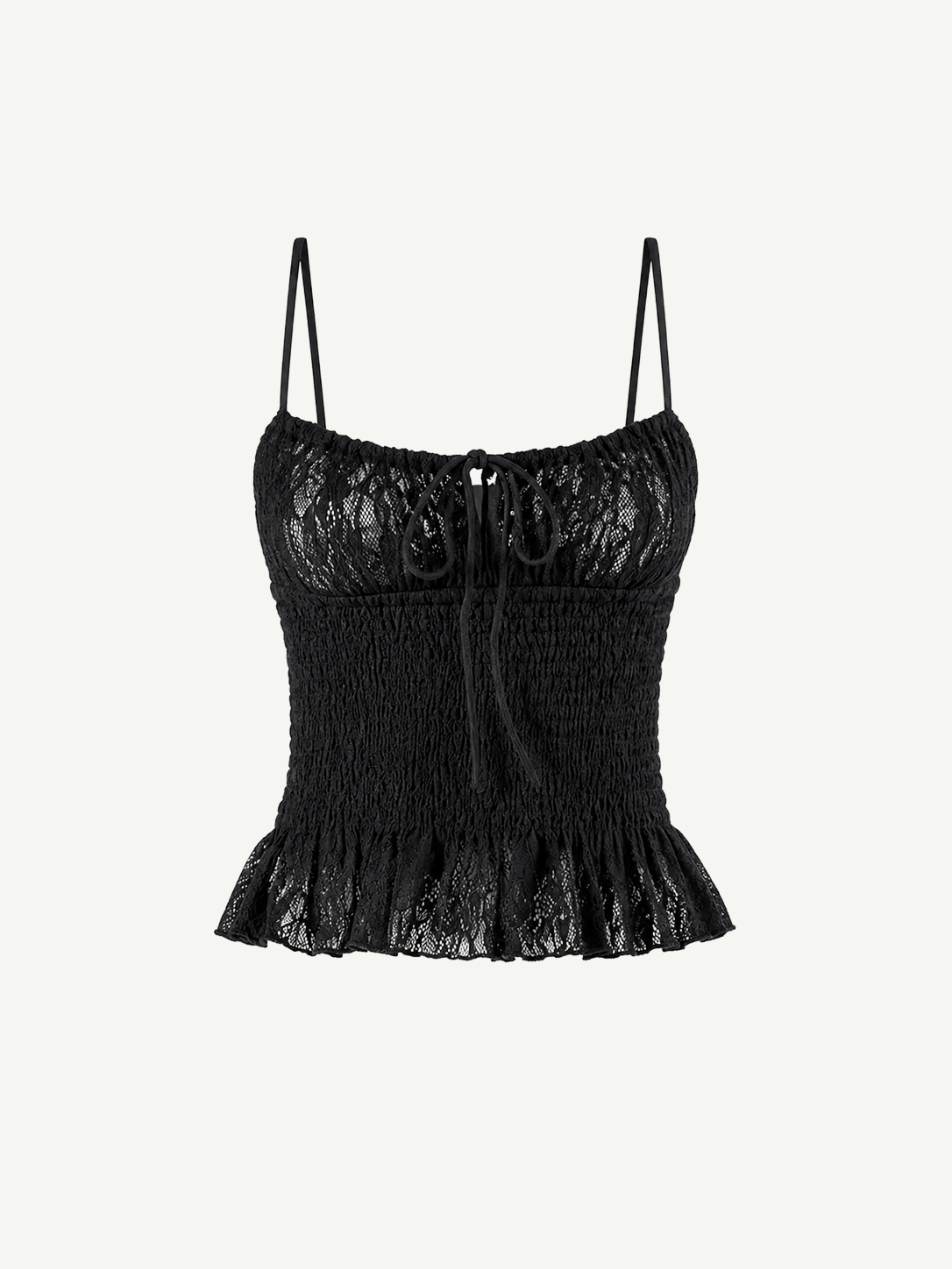 Introducing the Slip Top: a black lace camisole featuring adjustable shoulder straps, a ruched bodice, and a ruffled hem. This elegant Slip Top showcases a decorative bow at the neckline and a delicate floral lace pattern—perfect for pairing with ruffle pants or your favorite jeans.
