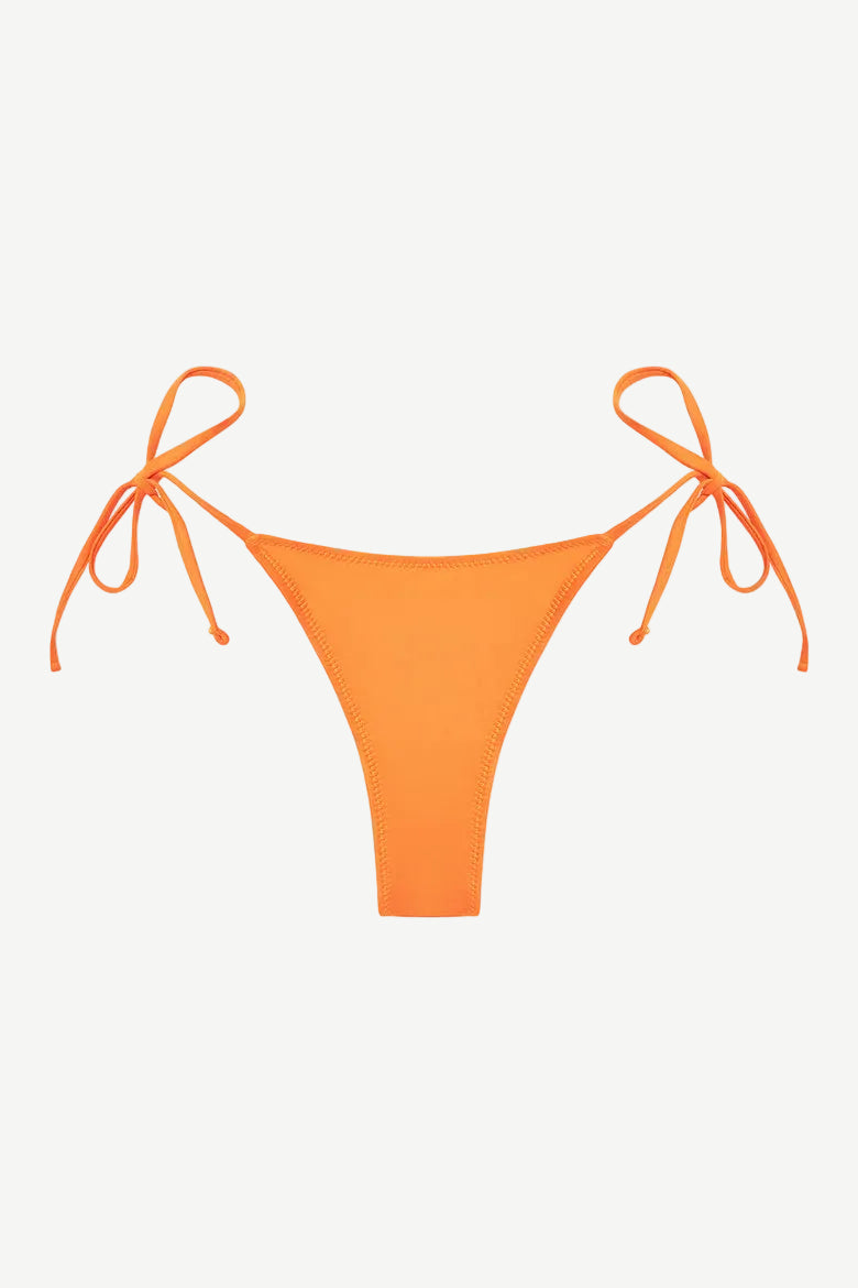The Praia Bottom, a bright orange triangle bikini bottom with adjustable side ties, crafted from our eco-friendly Peach Perfect fabric, is displayed on a plain white background.