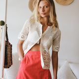 KABE SHOP INC Poolside Top in cream cotton crochet with short sleeves and open-weave floral patterns on a model.