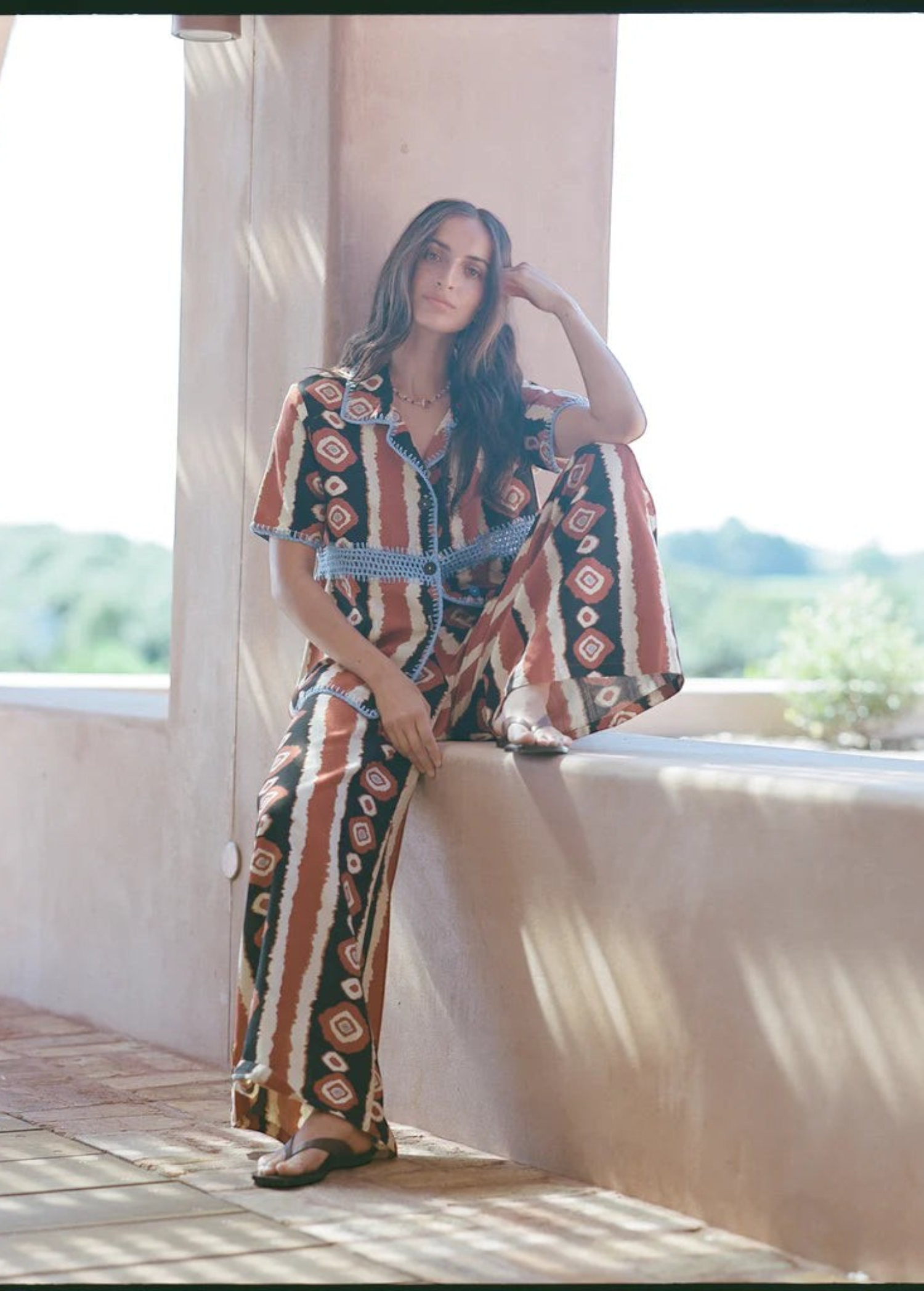 KABE SHOP INC Nera shirt featuring a brown and white ikat print with blue crochet detailing in an oversized fit.