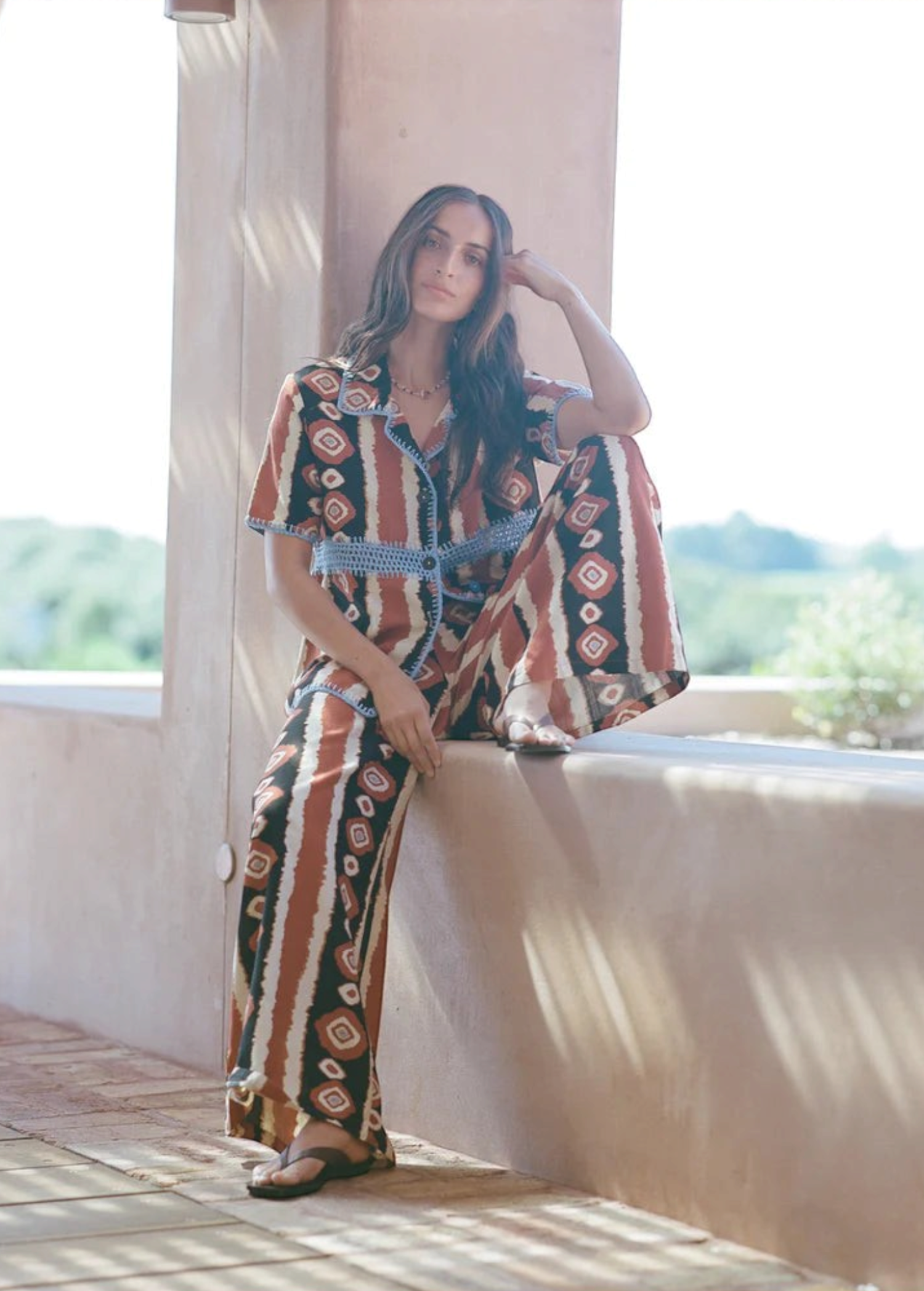 KABE SHOP INC Nera shirt featuring a brown and white ikat print with blue crochet detailing in an oversized fit.