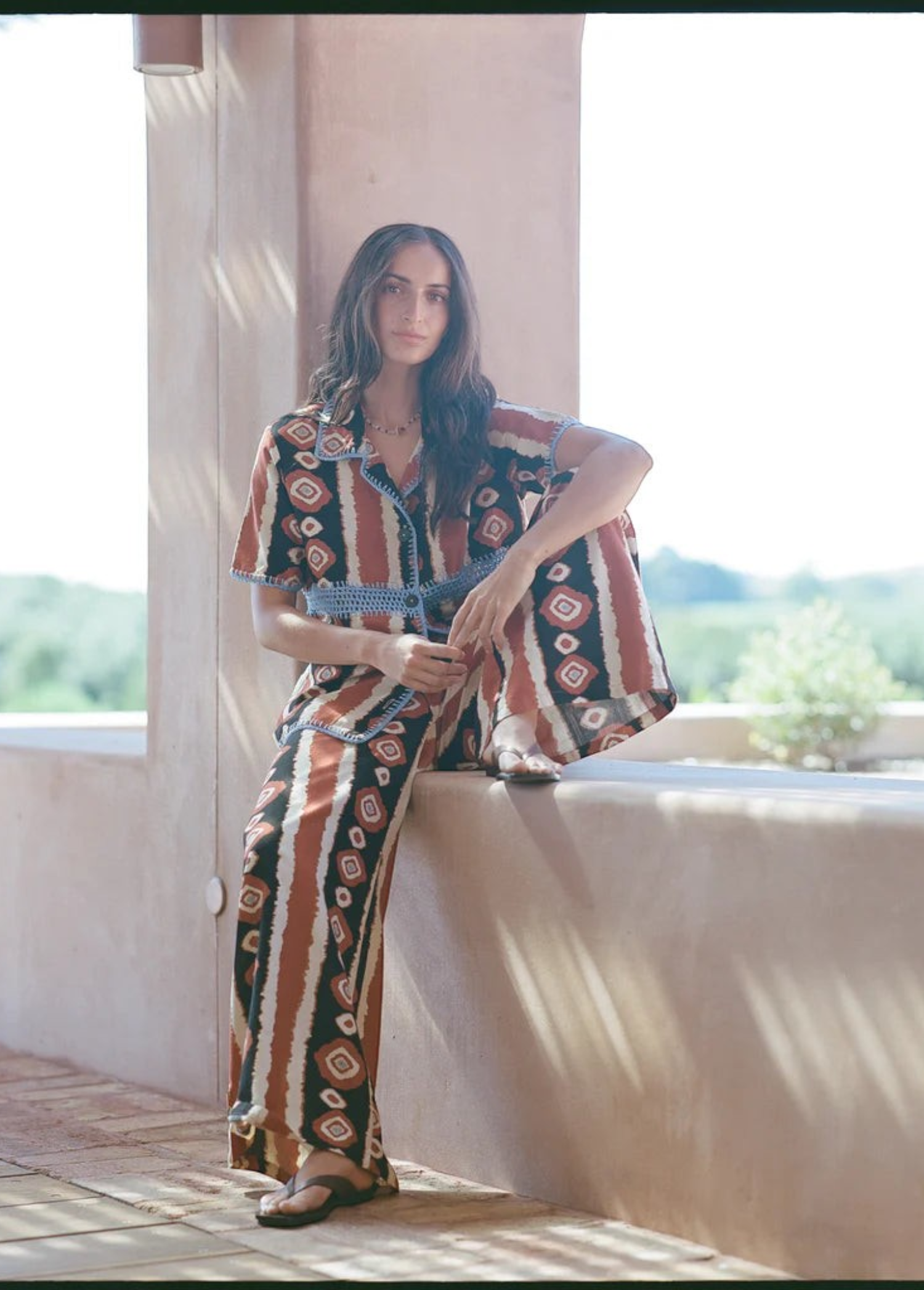 Model wearing KABE SHOP INC Nera shirt featuring an ikat print and crochet details in a relaxed oversized fit