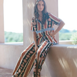 KABE SHOP INC Nera shirt featuring an ikat print and crochet detailing on a woman sitting in a sunlit archway