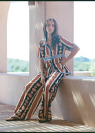 KABE SHOP INC Nera wide leg pants featuring a tribal ikat print in brown and cream, worn with a matching shirt.