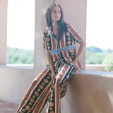 KABE SHOP INC Nera shirt featuring an ikat print and crochet details worn by a model in a relaxed outdoor setting.