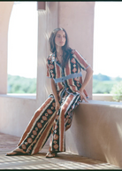 KABE SHOP INC Nera shirt featuring an ikat print and crochet details worn by a model in a relaxed outdoor setting.