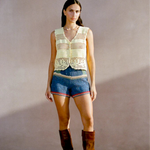 Model wearing a KABE SHOP INC Eva Vest, a pale yellow handcrafted crochet button-down top with intricate detailing.