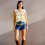 Model wearing KABE SHOP INC Nova Shorts featuring multicolored floral crochet motifs in a relaxed vacation style