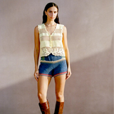 Model wearing KABE SHOP INC Nova Shorts featuring multicolored floral crochet motifs in a relaxed vacation style