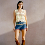 Model wearing a KABE SHOP INC Eva Vest, a cream-colored artisanal crochet button-down top with intricate detailing.