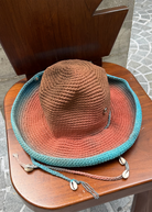KABE SHOP INC Wika crochet tie-dye hat with brown, orange, and blue gradient, featuring seashell accents on strings.