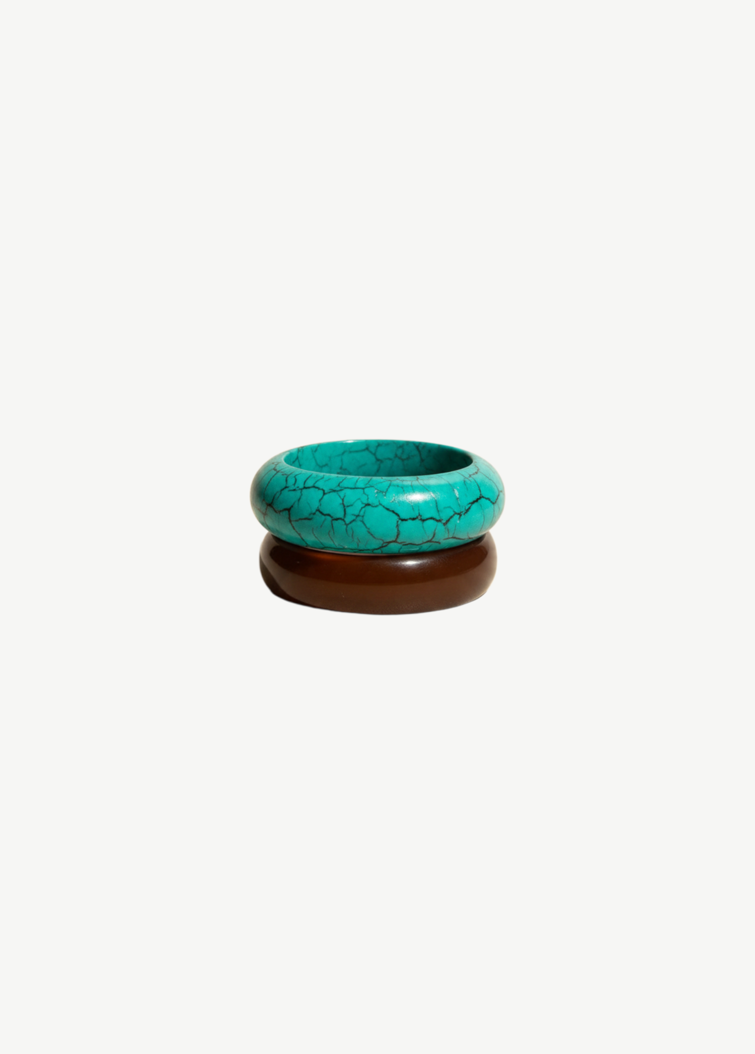 KABE SHOP INC resin bangle set featuring one turquoise crackle-patterned bracelet and one solid brown bangle