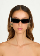KABE SHOP INC Colbi earrings featuring a bold geometric square design with a sleek silver-plated finish on a model