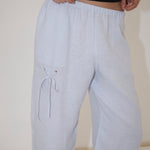 Light blue, straight-leg Deiji Studios Eyelet Pant with a drawstring eyelet detail on the right thigh.