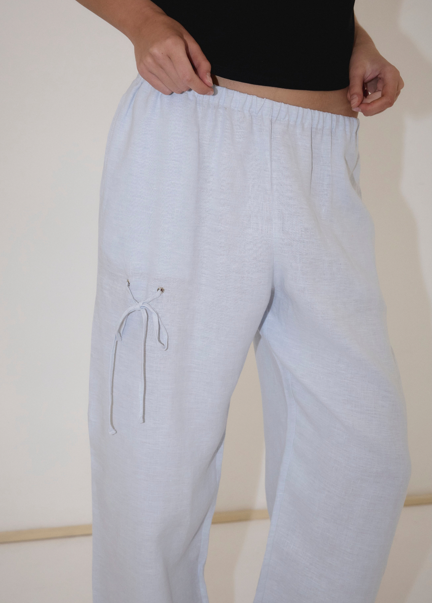 Light blue, straight-leg Deiji Studios Eyelet Pant with a drawstring eyelet detail on the right thigh.
