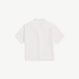 Back view of the white, short-sleeved Boxy Shirt Crochet in organic cotton, featuring a cropped, boxy fit and a crochet pocket.