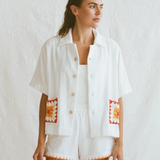 Boxy Shirt Crochet featuring an oversized white short-sleeved button-down shirt with square crochet pockets and matching shorts with a crochet hem.