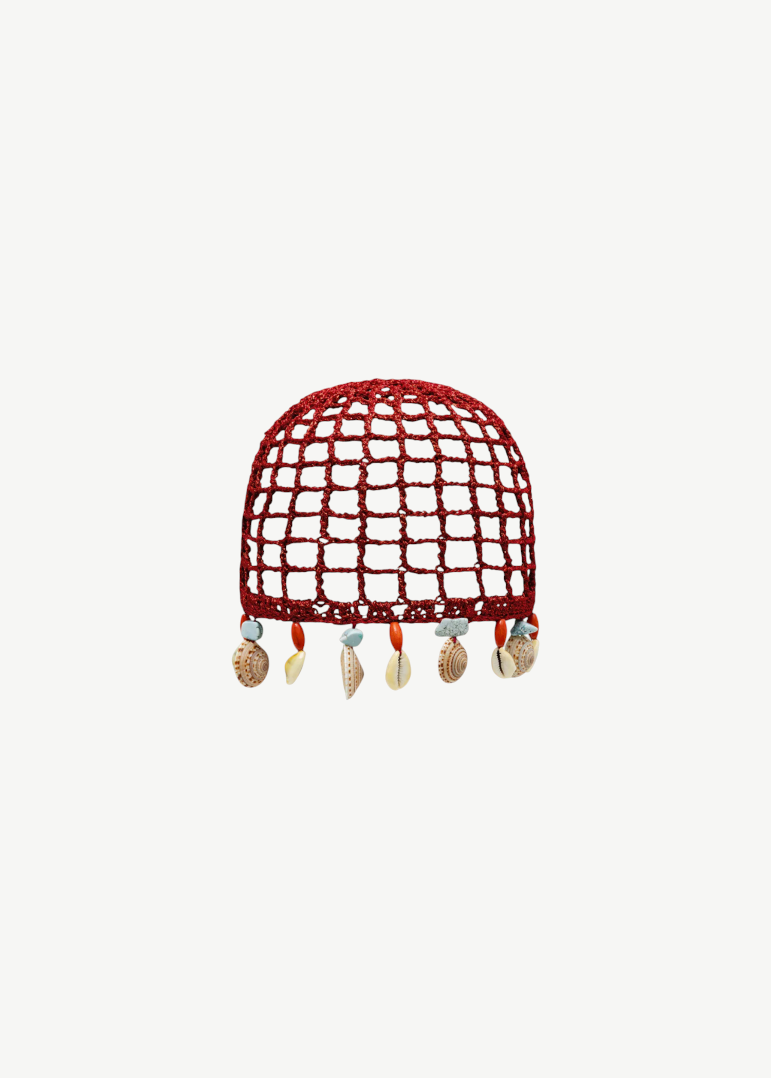 KABE SHOP INC Zahi Hat, a red crocheted skullcap featuring a grid pattern and dangling seashell and stone charms.