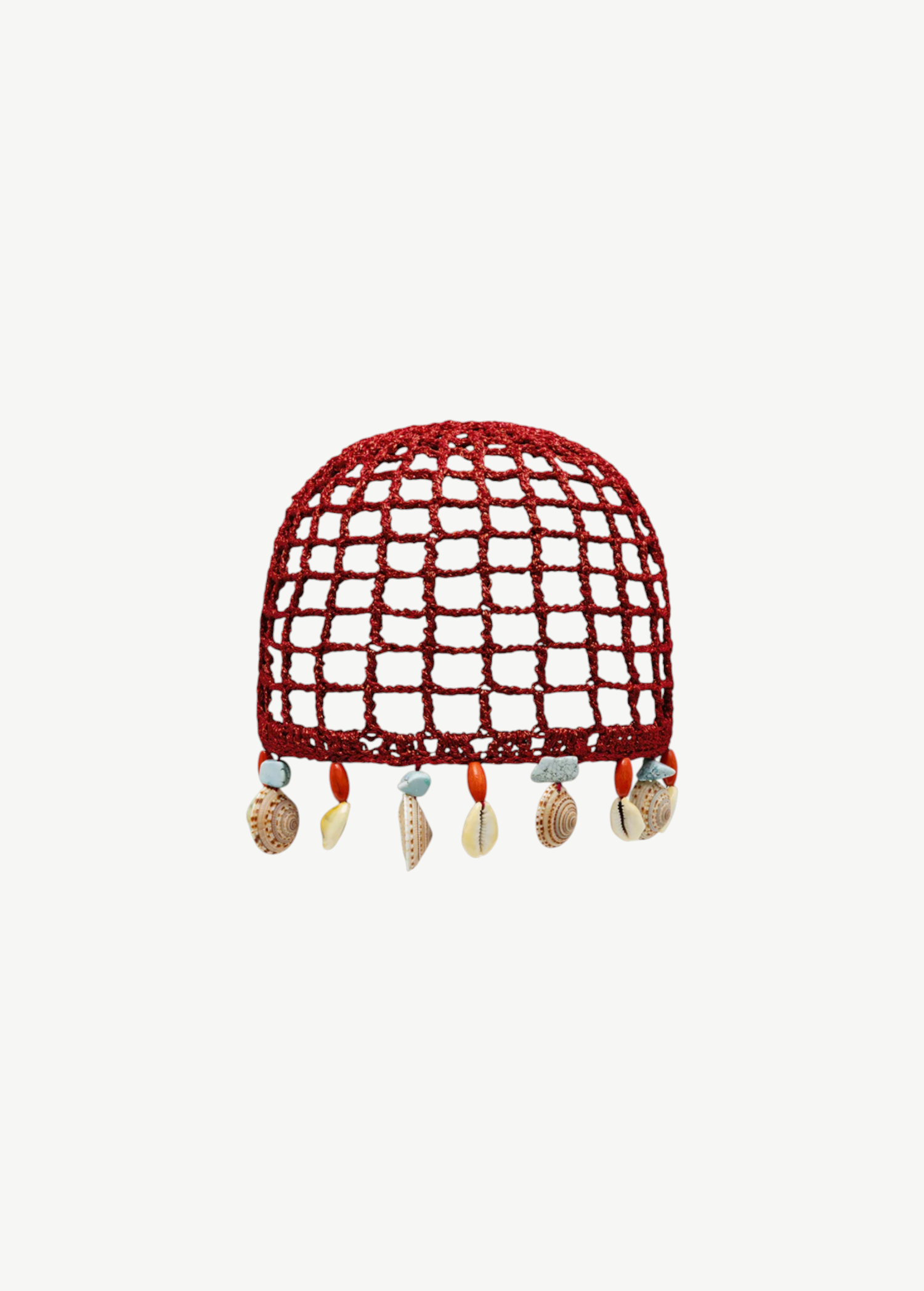 KABE SHOP INC Zahi Hat, a red crocheted skullcap featuring a grid pattern and dangling seashell and stone charms.