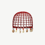 KABE SHOP INC Zahi Hat, a red crocheted skullcap featuring a grid pattern and dangling seashell and stone charms.