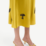 KABE SHOP INC Brigitte mule heels in mustard yellow satin paired with a matching midi skirt featuring mushroom motifs