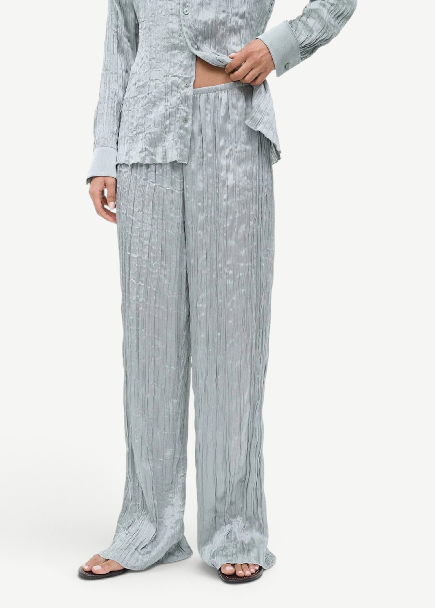 Sage green Nami Pant featuring a high-waisted, wide-leg design with a textured, crinkled finish in a relaxed silhouette.