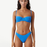 KABE SHOP INC ocean blue textured bikini brief with a high-cut leg and curved waistline on a model