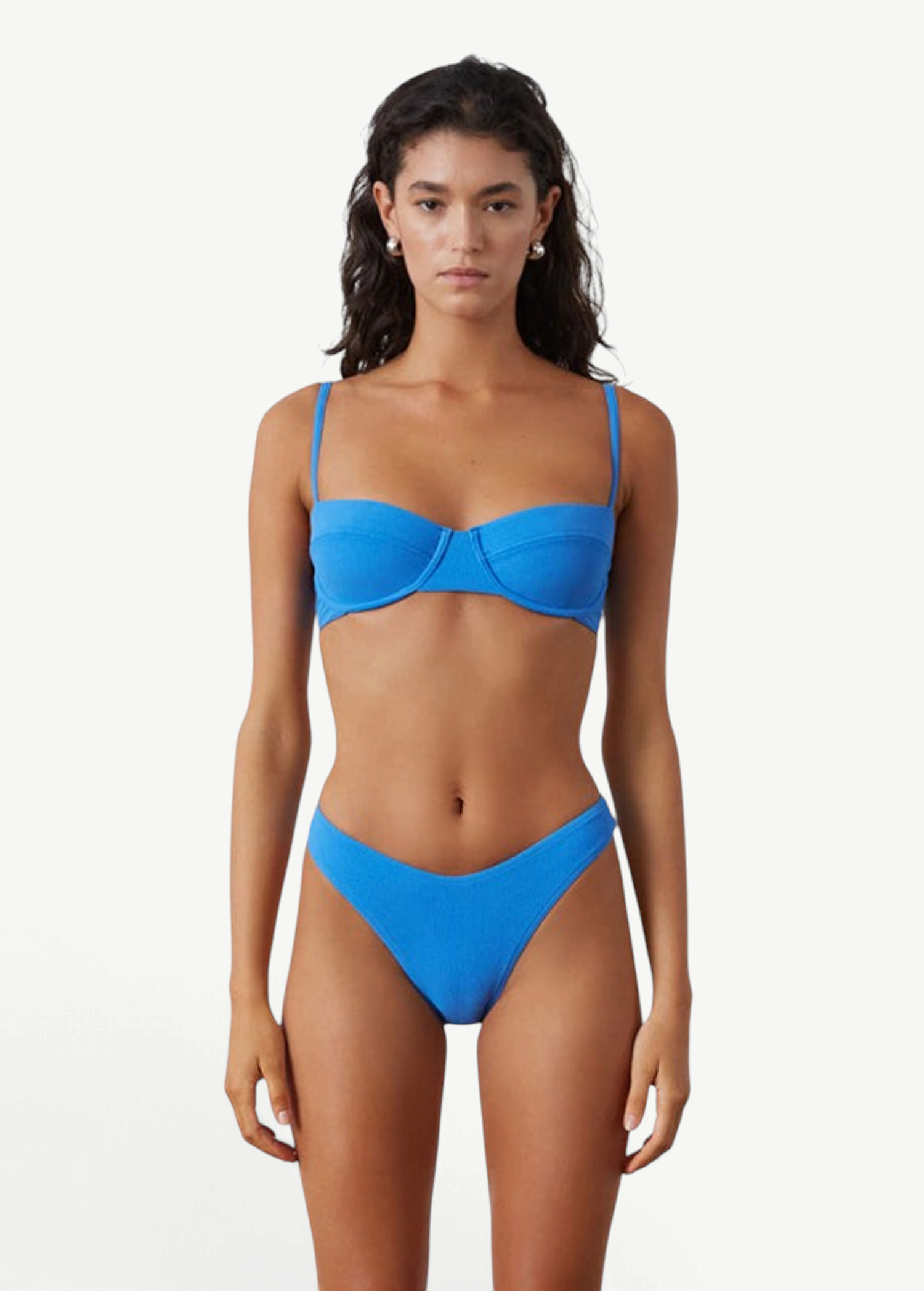 KABE SHOP INC ocean blue textured bikini brief with a high-cut leg and curved waistline on a model