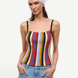 A person wearing a white headscarf and a multicolored striped Skye Tank with thin black straps.