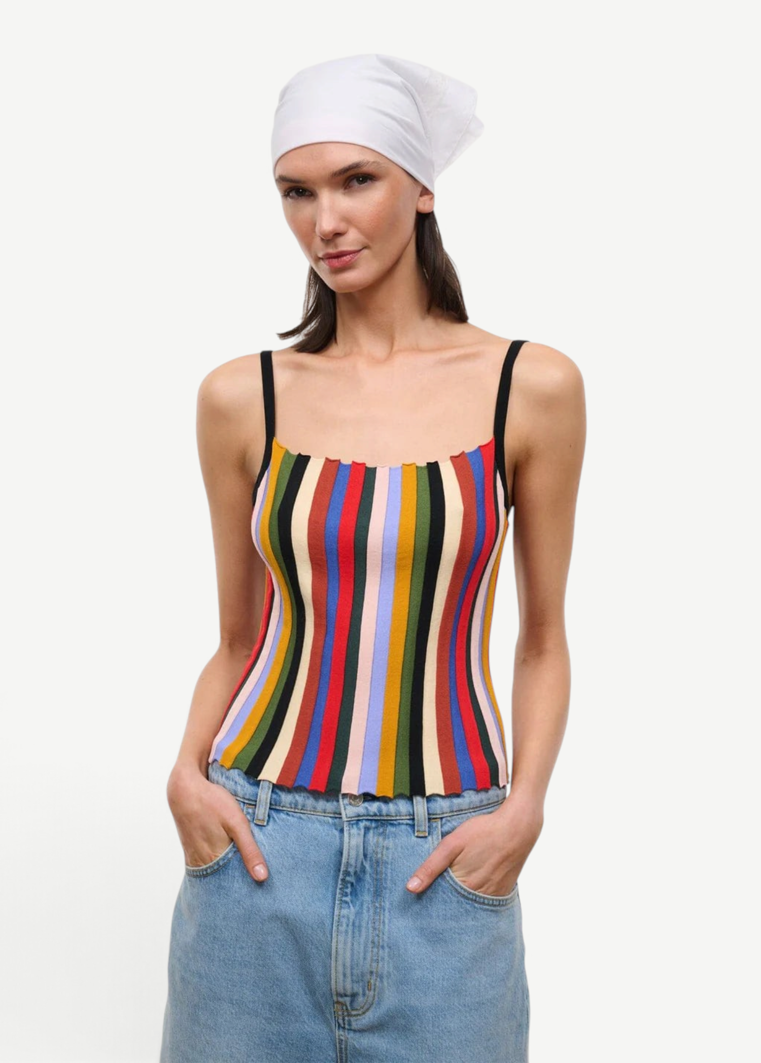 A person wearing a white headscarf and a multicolored striped Skye Tank with thin black straps.