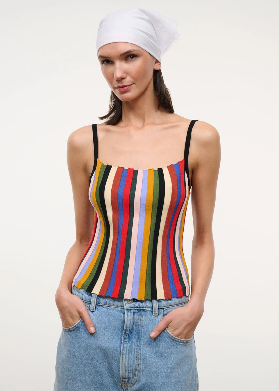 A person wearing a white headscarf and a multicolored striped Skye Tank with thin black straps.