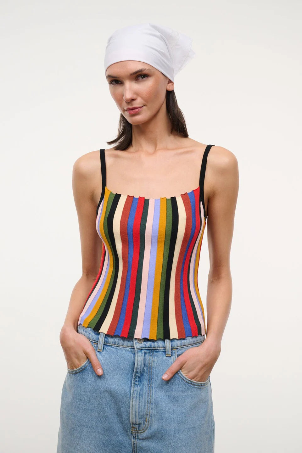 A person wearing a white headscarf and a multicolored striped Skye Tank with thin black straps.
