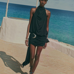 KABE SHOP INC Vida mini dress in black stretch jersey with a halterneck, cowl back, and silver crescent moon hardware.