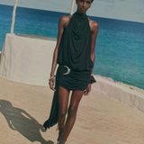 KABE SHOP INC Vida mini dress in black stretch jersey with a halterneck, cowl back, and silver crescent moon hardware.