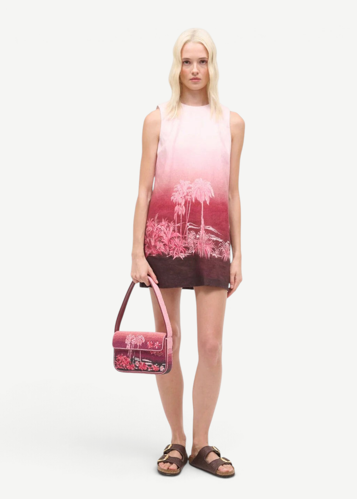 KABE SHOP INC Tommy beaded shoulder bag with pink California palm tree print held by a model in a matching dress