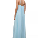A person wearing a light blue, floor-length Dasha Dress with a minimalist design and spaghetti straps.